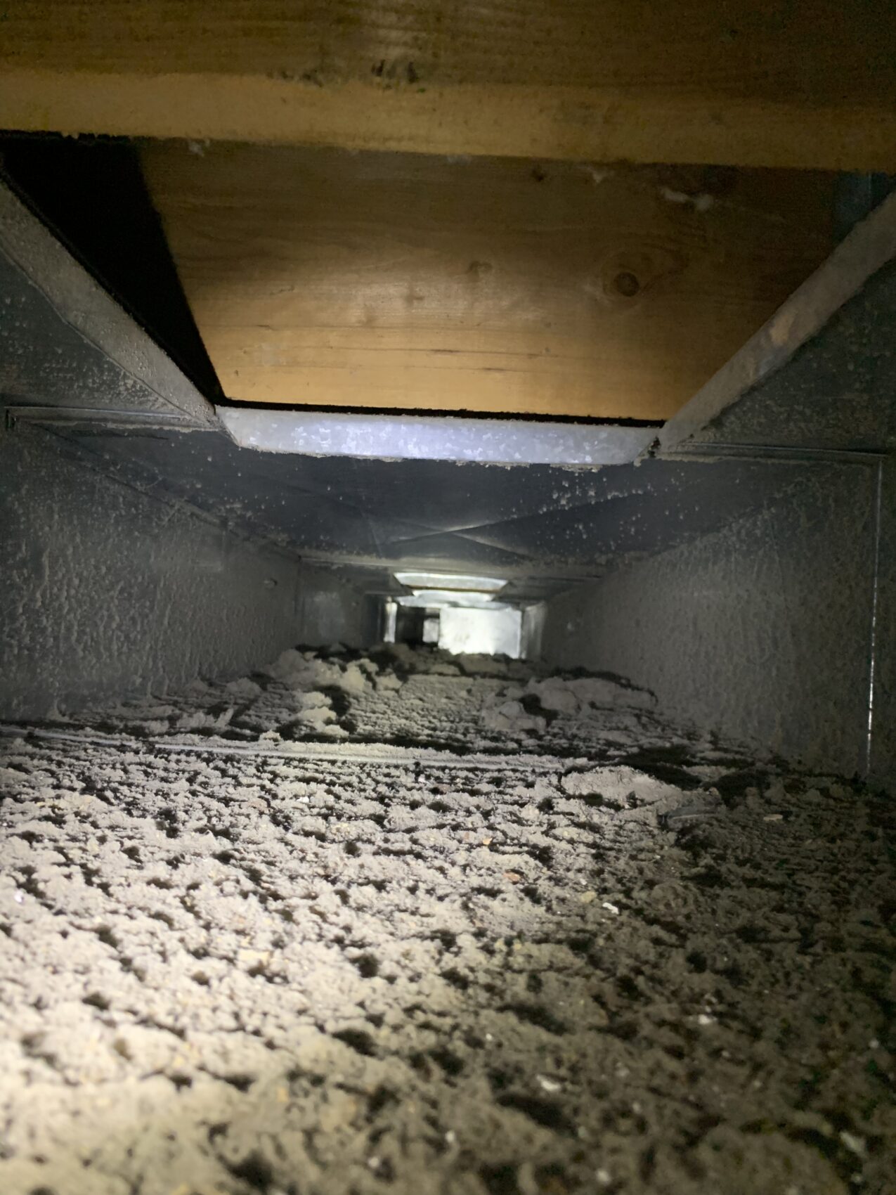 Duct interior with heavy dust buildup before cleaning